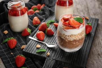 Delicious dessert with fresh strawberry on table