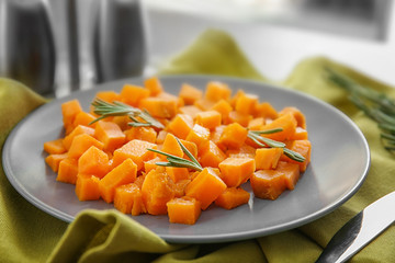 Plate with delicious sliced sweet potato on table