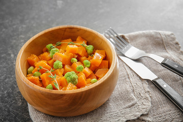 Dish with delicious sliced sweet potato on table