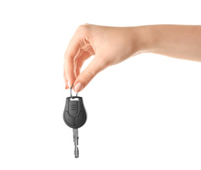 Woman holding car key on white background