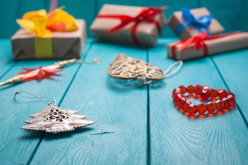 Turquoise background for Christmas cards. Blue wooden boards. Christmas gift. Holiday gifts are stacked.