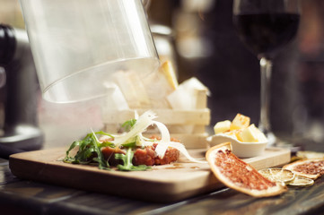 smoked tartar beefsteak on wooden plate
