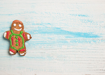 Gigerbread cookie adn wooden background with space for text