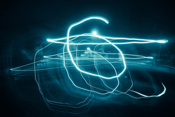 Blur colorful Abstract background of glowing stripes of streaks of light bands in a form of several lines on black background. Long Exposure.  