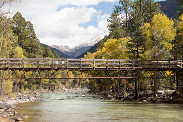 Fototapeta na wymiar Wood bridge over the Animas river in the San Juan mountains of Colorado