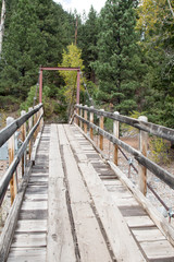 Wooden walking bridge over the Animas river in the San Juan mountains of Colorado