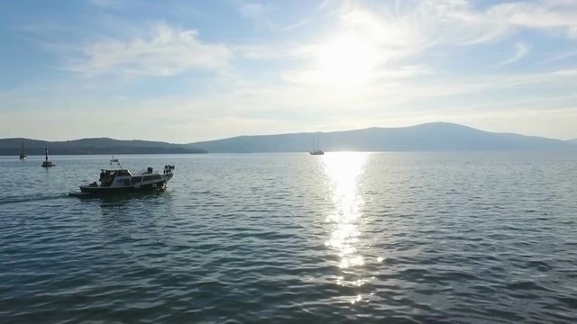 Aerial view of a floating boat in the sunlight