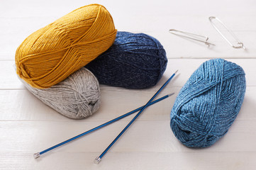 Pile skeins of yarn and knitting needles