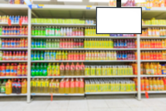 Blank supermarket TV screen and blurred supermarket drinks background