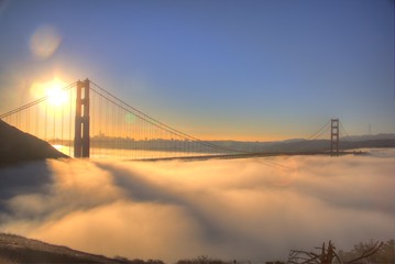 Spectacular Sunrise at Golden Gate Bridge with low fog. 