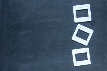 Plastic film slides on chalkboard background