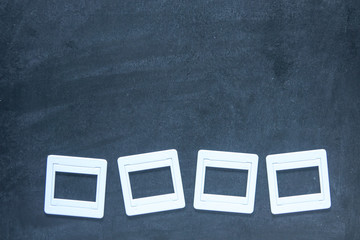 Plastic film slides on chalkboard background