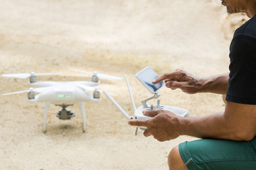 man playing quad copter drone for taking aerial  photography