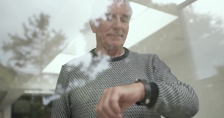 Senior man using smartwatch - Powered by Adobe