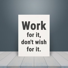 Inspiration Quote " Work for it,don't wish for it" on paper at wooden table top and dark blue wall background.