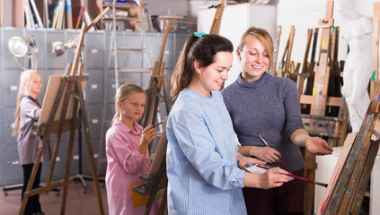 Girls diligently training their painting skills drawing class