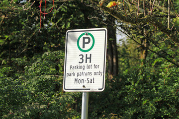 A parking sign for a park