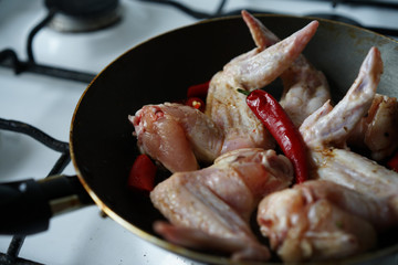raw chicken wings with red pepper