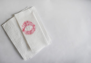 Fototapeta na wymiar Pink lipstick on napkin white and top teble surface of clean for background and empty space for text.