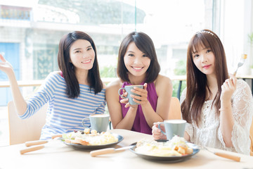 happy woman friends in restaurant