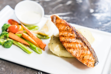 salmon steak with mash potato and vegetable