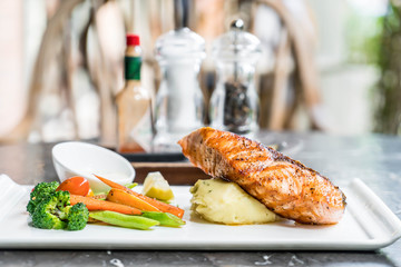 salmon steak with mash potato and vegetable