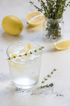 Detox water with lemon and thyme in glass