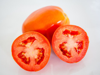 Red tomato on white background.
