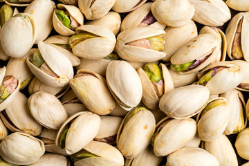 Healthy and delicious roasted salted pistachio nuts background texture from top view
