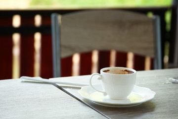 Used coffee cup put on the top of table.