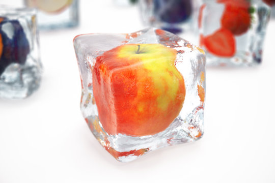 Apple in ice cube isolated on white with depth of field effects. Ice cubes with fresh berries. Berries fruits frozen in ice cubes, 3D rendering