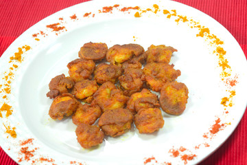 Indian fried prawns on a white plate 
