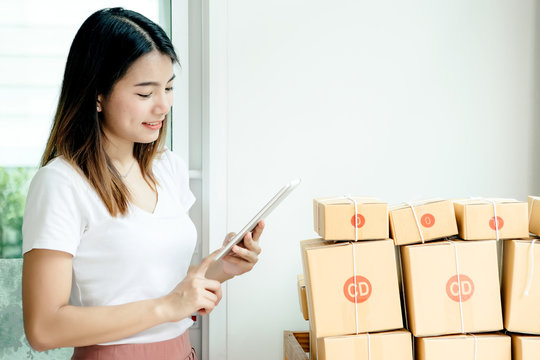 Young asian girl is freelancer with her private business at home office, working with laptop, coffee, online marketing, Customer order and packaging or packing.
