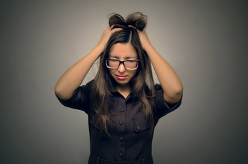 Stressed woman feeling headache and holds her hand behind her head. Can't solve problem.