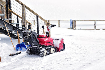 The petrol snow blower in snowfal