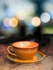 Obraz premium hot coffee cup on old wood table background