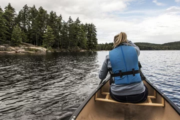Foto op Canvas Girl canoeing with Canoe on the lake of two rivers in the algonquin national park in Ontario Canada on sunny cloudy day © CL-Medien