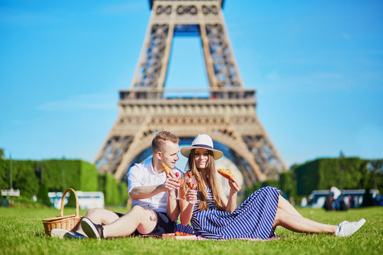 Couple having picnic near the Eiffel tower in Paris, France