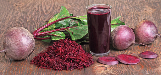 Healthy food - beets and beets juice on wooden background
