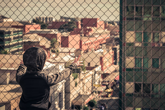 Boy standing on top of the roof