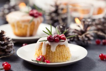 Christmas mini cake with sugar icing, cranberries and rosemary