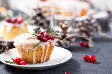 Christmas mini cake with sugar icing, cranberries and rosemary