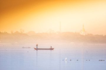 Fototapeta na wymiar Lifestyle of fishermen on sunrie at lake near U bein bridge at Amarapura ,Mandalay, Myanmar