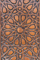 Relief ornament on a brown wooden surface
