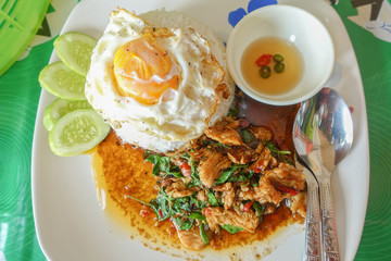 Fried chicken basil on top cooked rice, thai food.