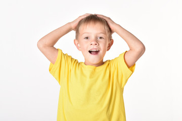 A boy on a white background. A good baby. A beautiful mood. Hands on the head. A great annoyance.