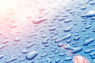 Drops on wet glass in the sunlight, background