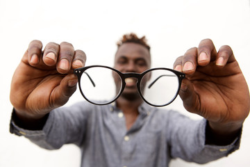Close up of male hands holding a pair of glasses