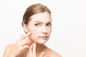 Obraz na płótnie Canvas Caucasian woman who checks her skin. acne treatment.