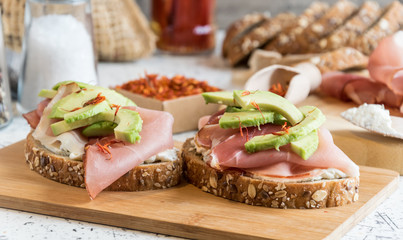 fresh bread with cottage cheese, prosciutto , avocado and saffron